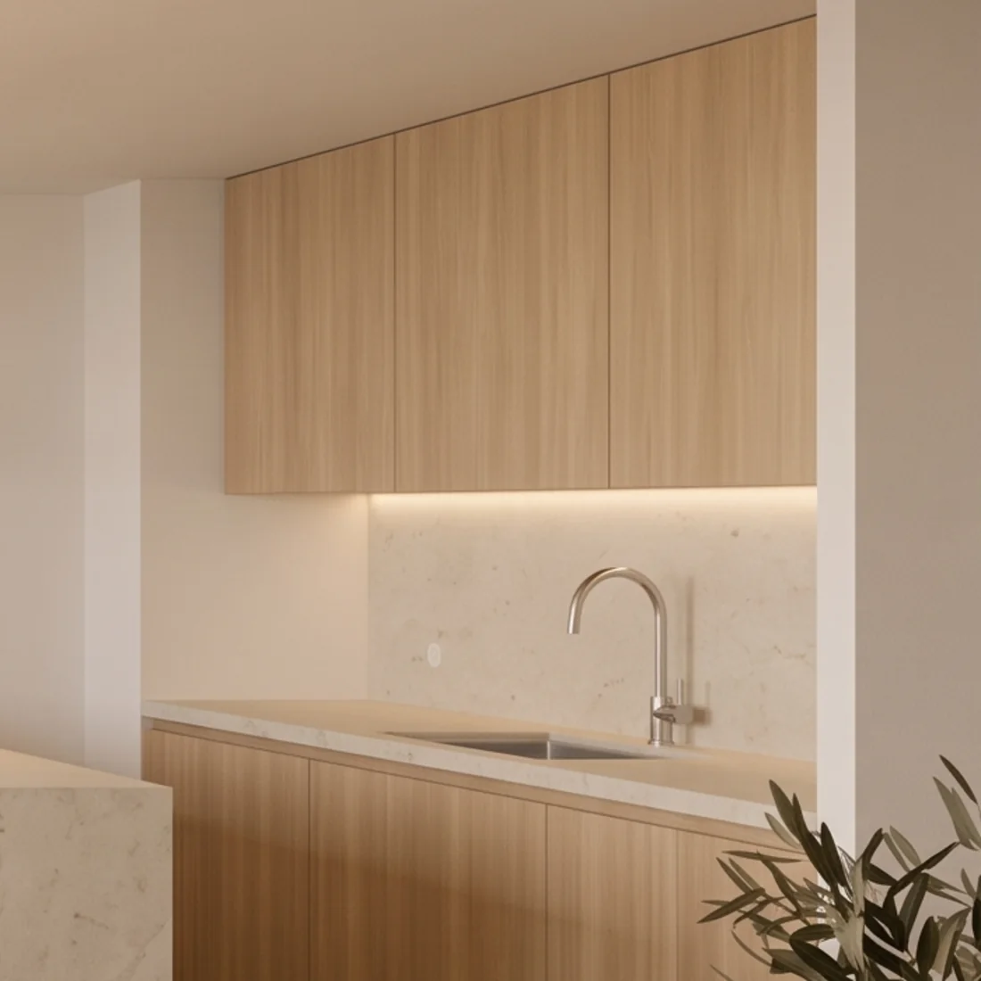 Oak kitchen front with a pale worktop and steel tap