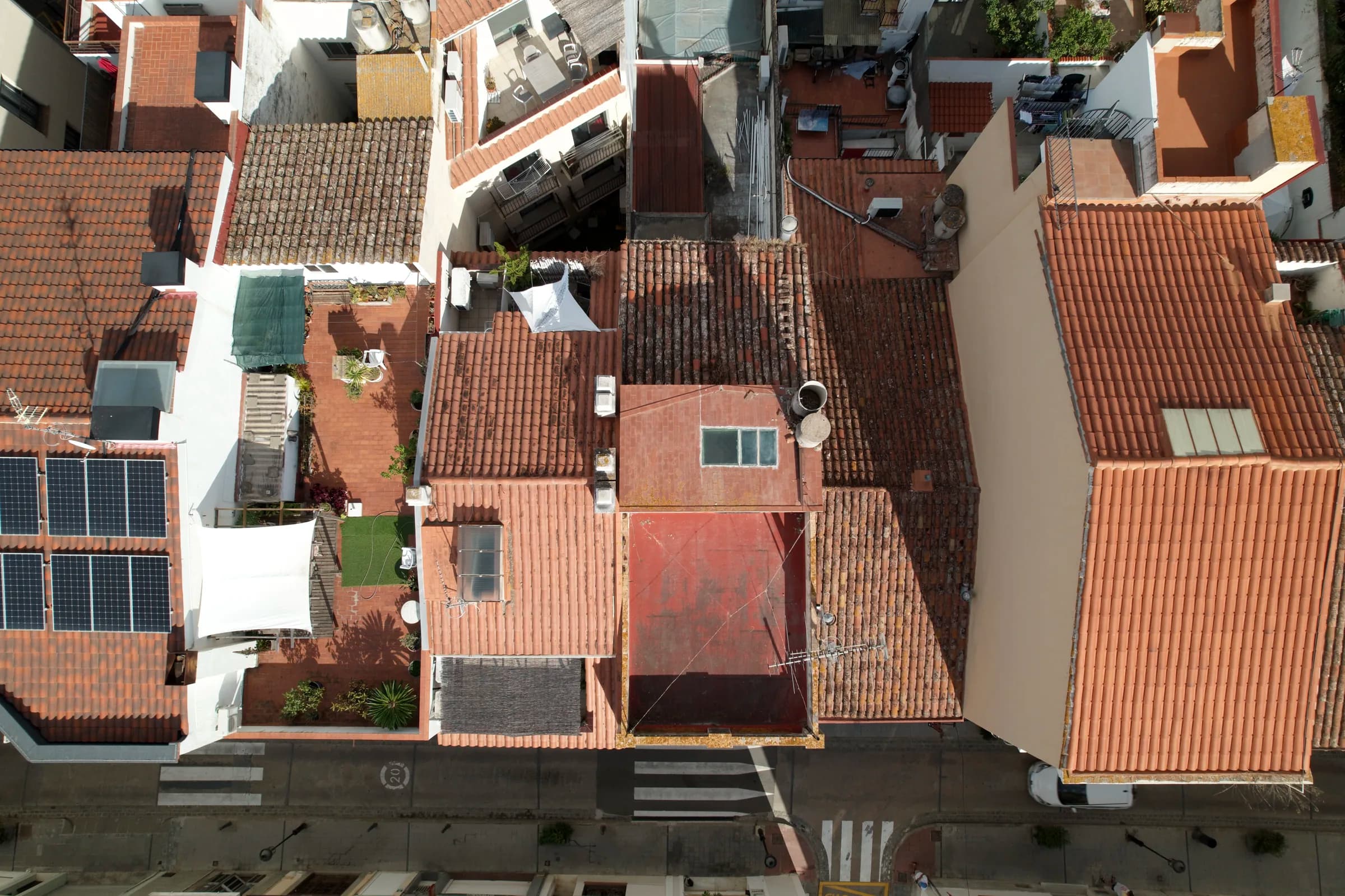Overhead drone view of the roofs and courtyards of the old town block