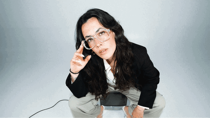 Una mujer con las gafas puestas sobre fondo claro, en la pieza que explica la lente